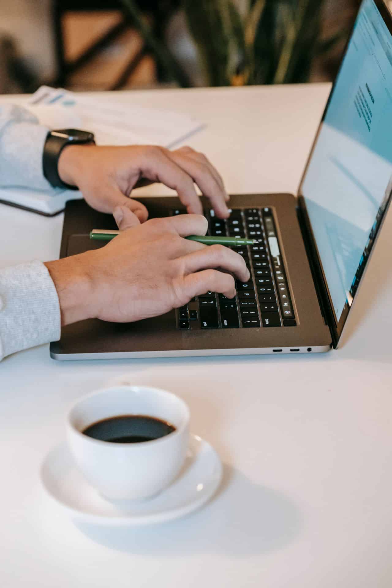 A student getting started on homework with coffee and a laptop